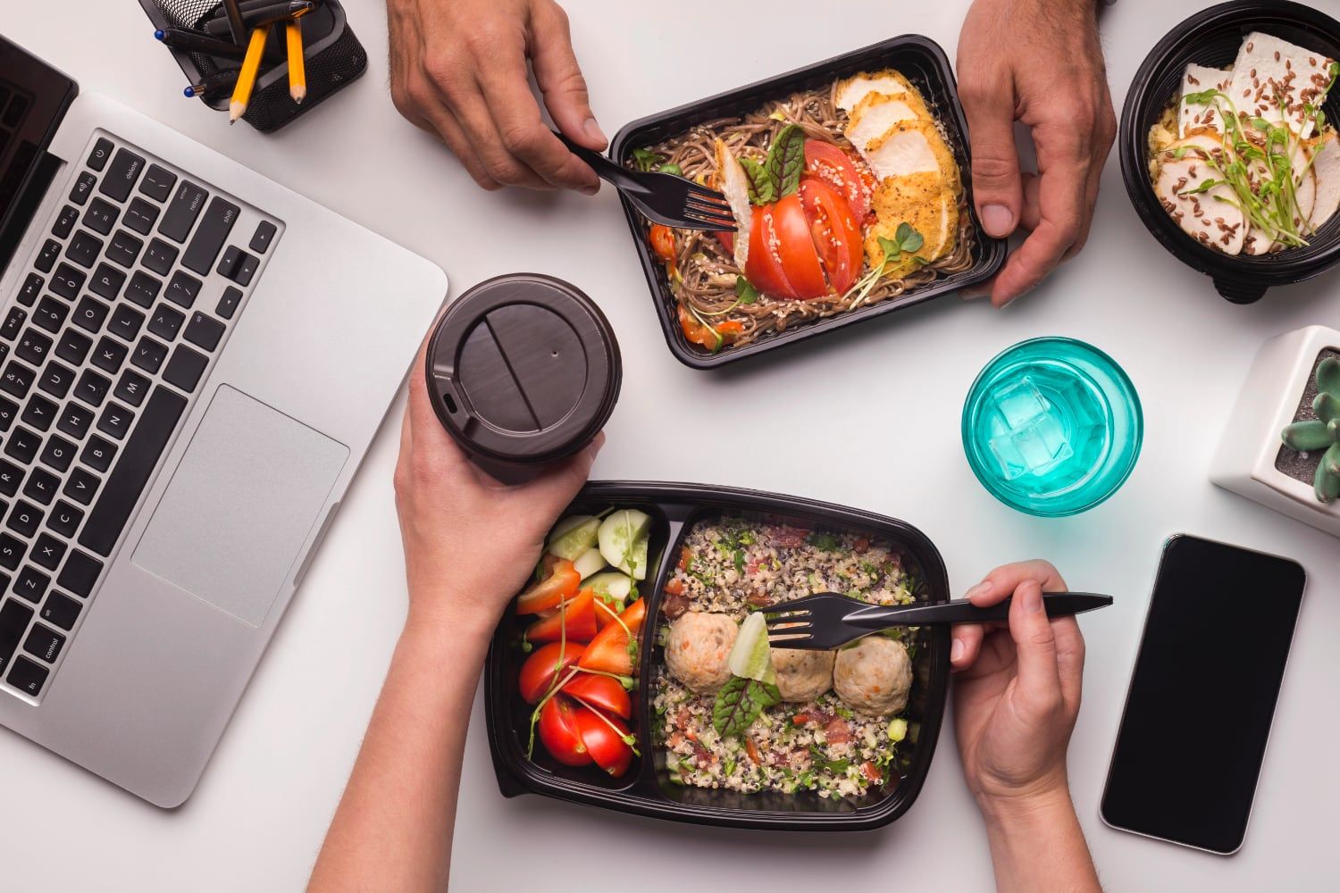 person eating healthy food from a packaged box